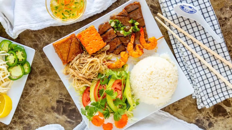 62. Charbroiled Pork, Beef or Chicken, Shredded Pork Skin, Steamed Egg Pork Patty & Shrimp Paste Cake Over Rice